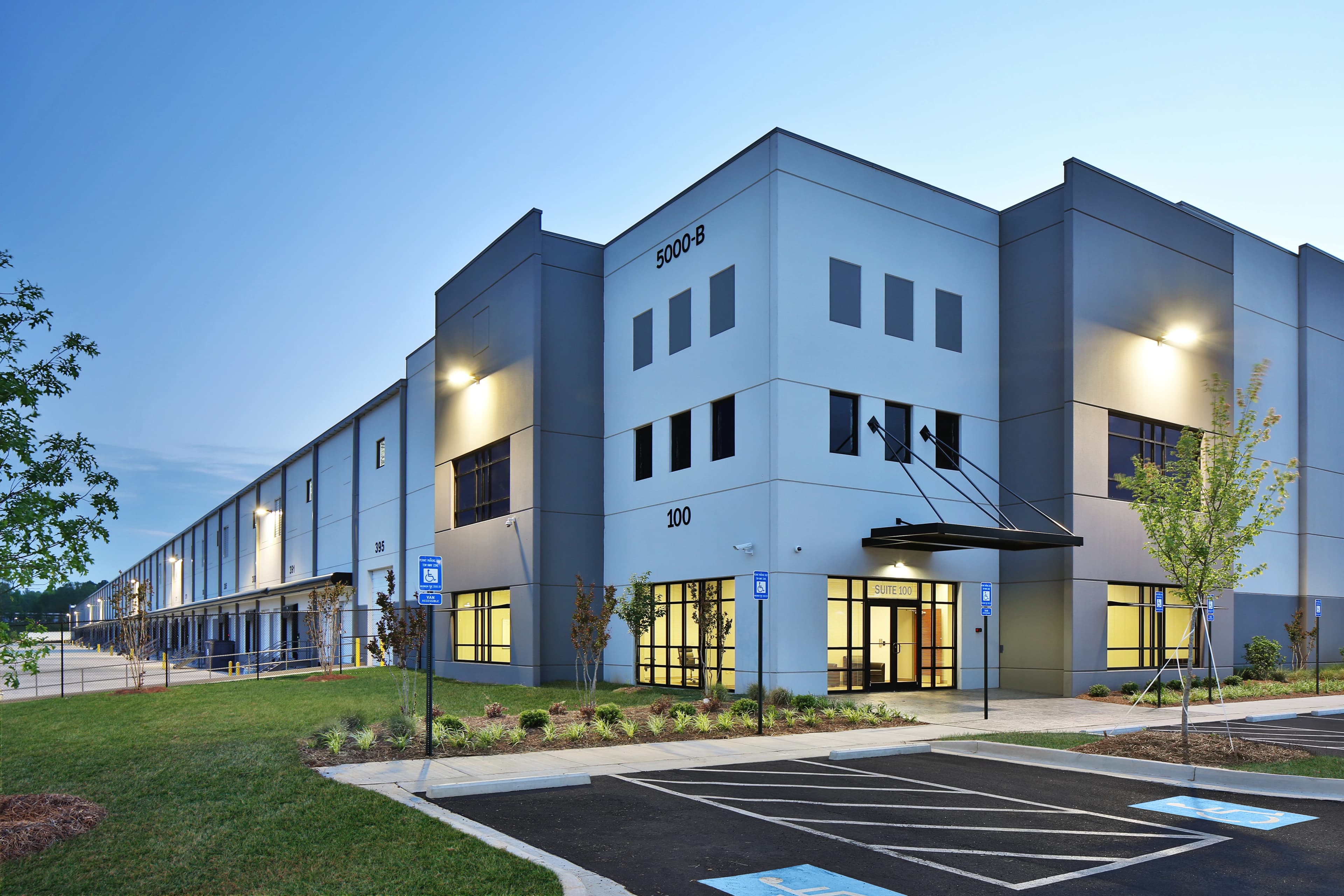 Hero image of an modern business complex building at dusk